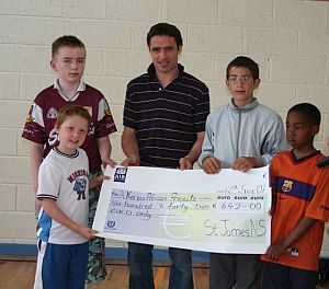 Alan Kerins receives a cheque from St. James' National School